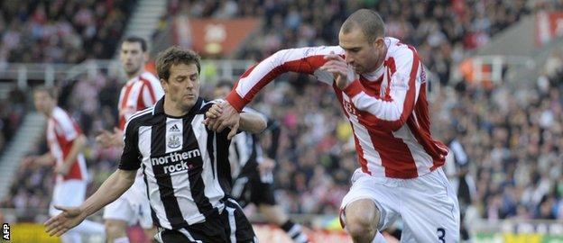 Danny Higginbotham and Michael Owen tussle for the ball