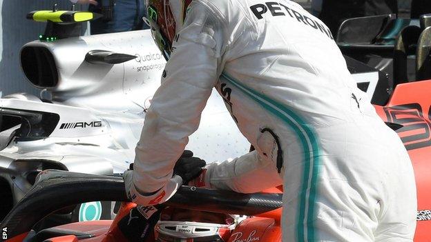 Lewis Hamilton shakes the hand of Charles Leclerc in the parc ferme