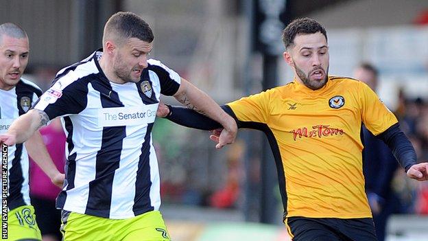 Robbie Willmott of Newport is challenged by Notts County's Carl Dickinson