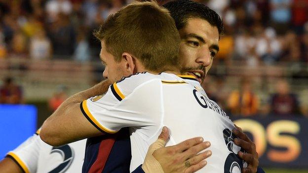 Luis Suarez and Steven Gerrard embrace before a friendly in Los Angeles