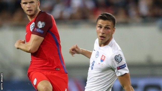 Filip Kiss (right) looks on as England midfielder Eric Dier takes a shot against Slovakia at Euro 2016