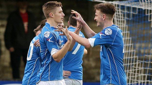 Dungannon players celebrate after Andrew Burns's equaliser at Stangmore Park