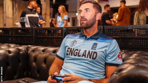 England player Liam Plunkett plays Playstation during the kit launch