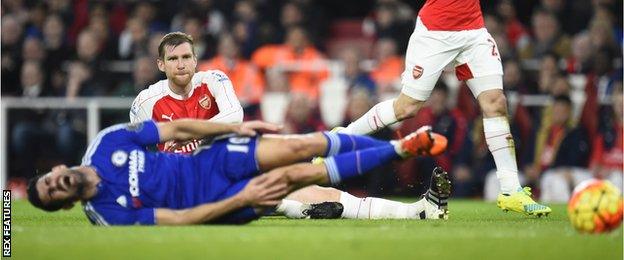 Per Mertesacker looks on after fouling Diego Costa