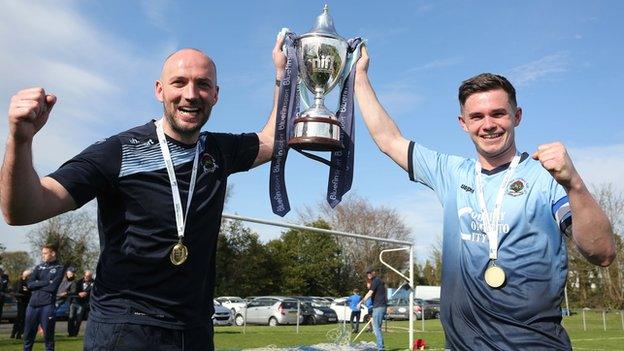 Institute boss Paddy McLaughlin and captain Michael McCrudden celebrate winning the Championship