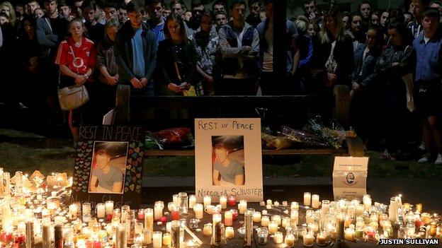 People gather at the Martin Luther King Jr. Civic Center Park to mourn the loss of the students