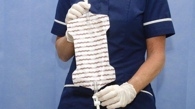 Nurse holding catheter bag