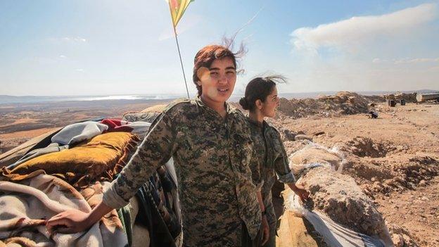 Women fighters from a Kurdish People's Protection Unit at a check point on the outskirts of the destroyed Syrian town of Kobane