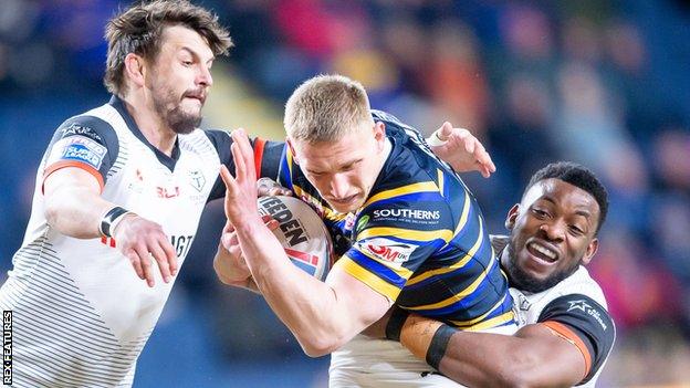 Leeds' Mikolaj Oledzki is tackled by Toronto's Jon Wilkin and Gadwin Springer