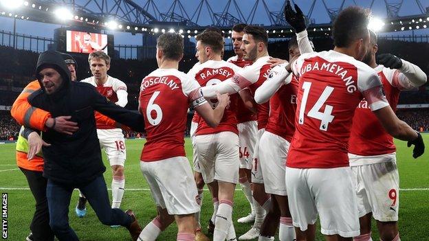 A fan on the pitch at Emirates Stadium