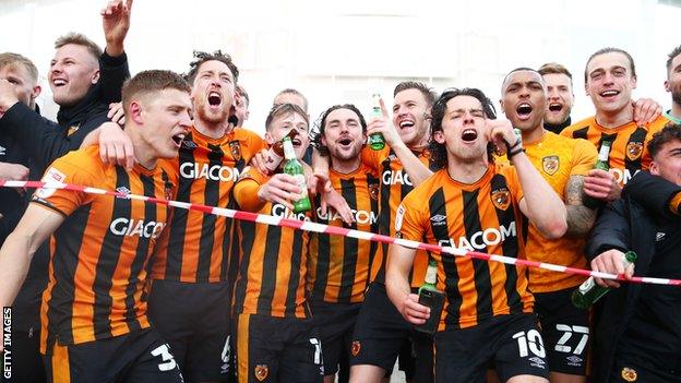 Hull City's players and coaching staff celebrated outside their KCOM Stadium home following their title-winning victory over Wigan Athletic