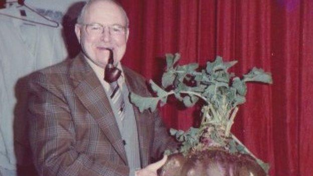 Man holding giant swede