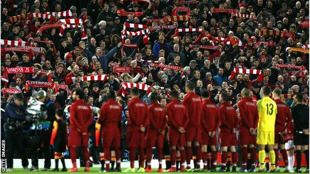 Liverpool fans salute the team