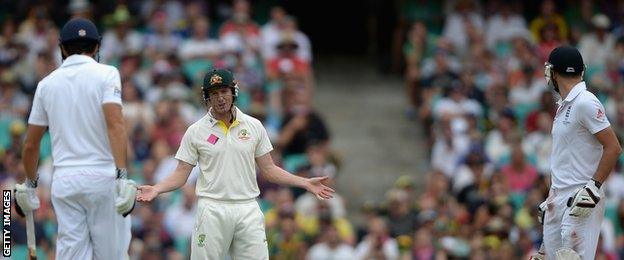 England captain Alastair Cook (left) and James Anderson (right) speak with George Bailey (centre) of Australia