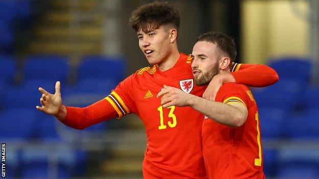 Rubin Colwill celebrates his first international goal with Rhys Norrington-Davies