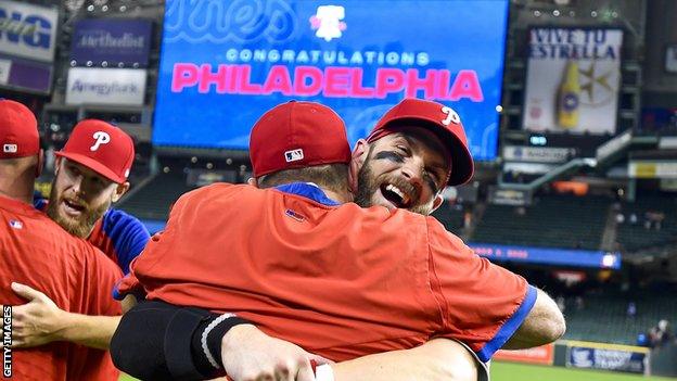 Philadelphia Phillies' Bryce Harper hugs a member of the coaching staff at Houston's Minute Maid Park