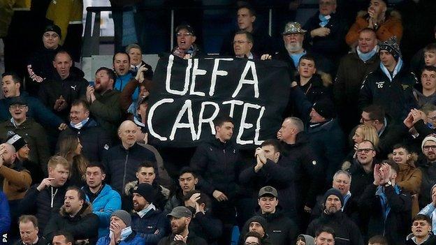 Manchester City fans with anti-uefa banners