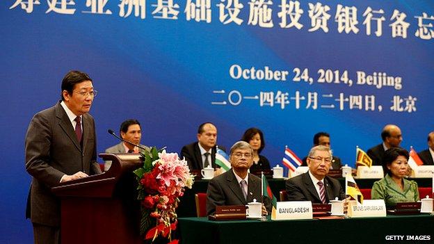 Chinese Finance Minister Lou Jiwei (L) speaks during the signing ceremony of the Asian Infrastructure Investment Bank on 24 Oct, 2014 in Beijing, China