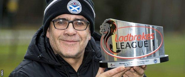 Ian McCall with his manager of the month award for November