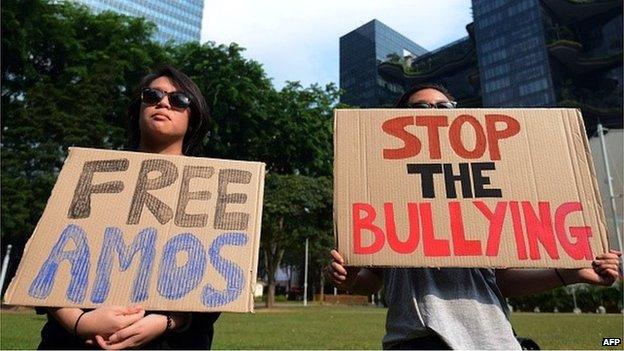 Member of the public hold up placards in support of 16-year-old Amos Yee who is behind online attacks on late former prime minister Lee Kuan Yew in Singapore on July 5, 2015.