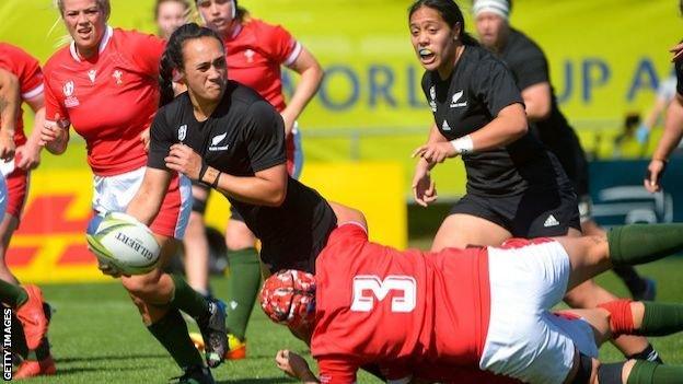 New Zealand's captain Ruahei Demant passes the ball while tackled by Wales' Donna Rose