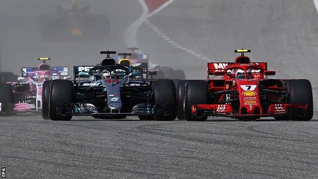 Ferrari's Kimi Raikkonen overtakes Mercedes' Lewis Hamilton on the first lap