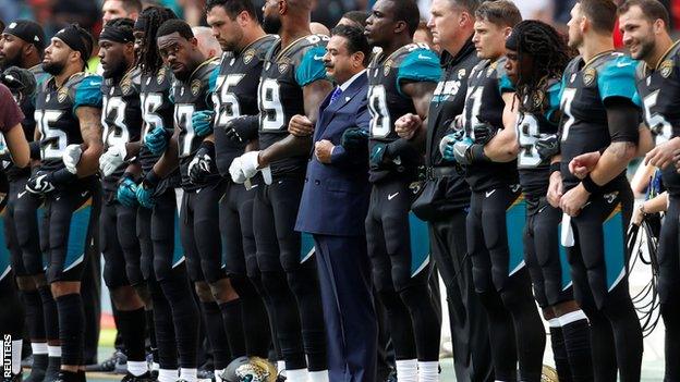 Jacksonville Jaguars owner Shad Khan (centre) with players