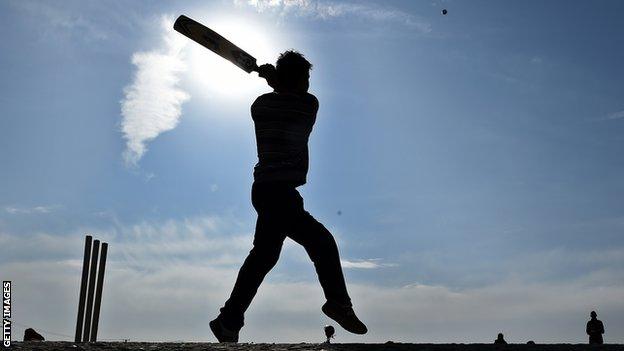 Cricket player in silhouette