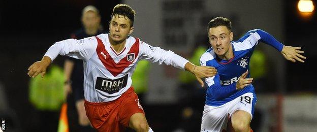 Airdrieonians' Jamie Bain tussles with Barrie McKay