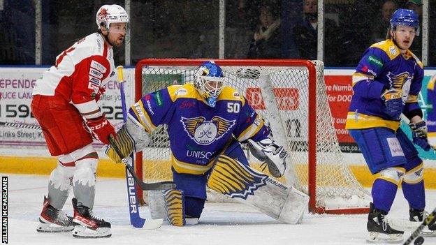 Cardiff Devils' Brodie Reid in front of Flyers goalie Shane Owen