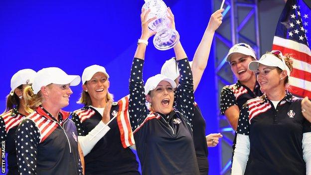 Cristie Kerr of the United States lifts the Solheim Cup aloft after their triumph