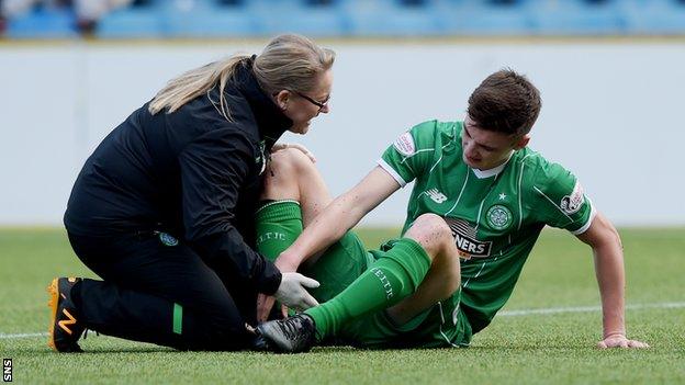 Celtic defender Kieran Tierney receives treatment on an ankle injury