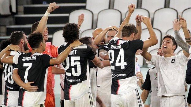 Juventus players celebrate after clinching the title