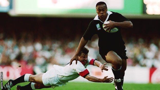 Jonah Lomu evades Rob Andrew's tackle in England's defeat by New Zealand