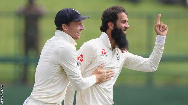 England's Jos Buttler celebrates with Moeen Ali after Moeen took a wicket on day five of the second Test against Sri Lanka