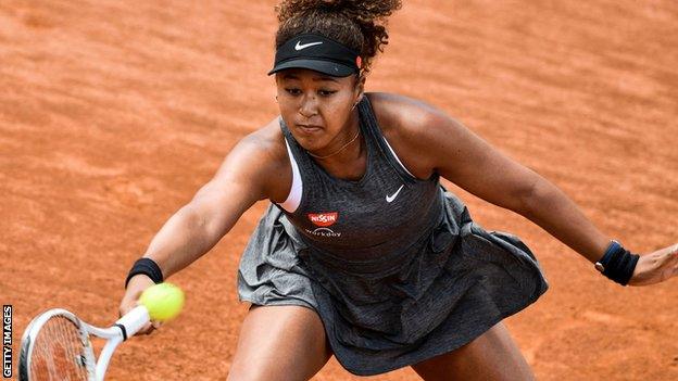 Naomi Osaka hits a return in her Italian Open match against Jessica Pegula