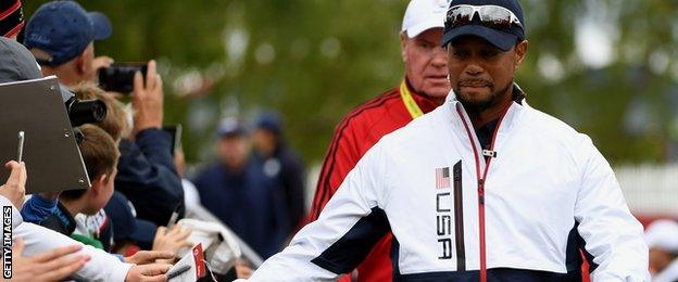 Vice-captain Tiger Woods of the United States high fives fans during practice prior to the 2016 Ryder Cup