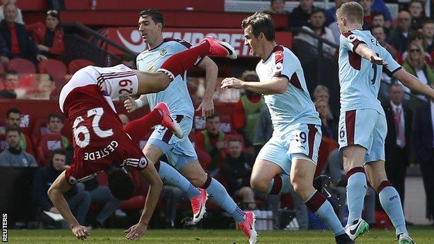 Rudy Gestede (left) goes tumbling the the Burnley area - no penalty though