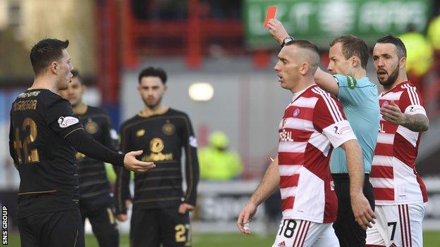 Referee Willie Collum shows Callum McGregor a red card early in the second half