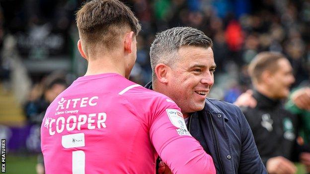 Steven Schumacher (right) congratulates goalkeeper Michael Cooper, who has conceded just five goals in 13 League One games since the start of February