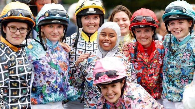 Khadijah Mellah picture at Goodwood with rival jockeys