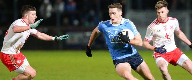 Two Tyrone players attempt to halt the run of Dublin's Brian Fenton at Healy Park