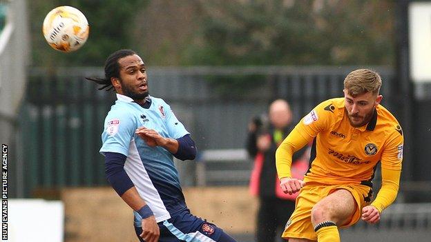 Dan Butler clears the ball under pressure from Blackpool Nathan Delfouneso