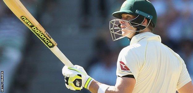 Steve Smith raises his bat after passing 50