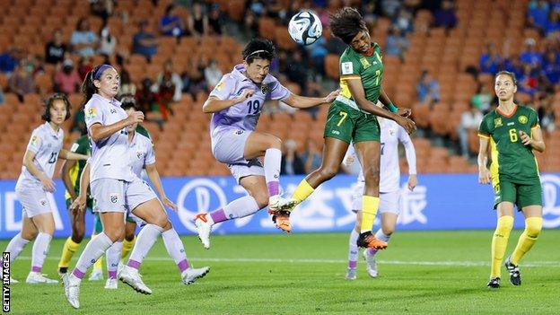 Gabrielle Onguene competes with the Thailand defence for a header