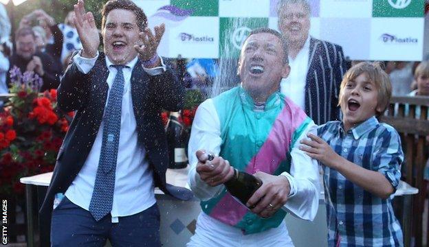 Frankie Dettori celebrates with his sons Leo (L) and Rocco after riding his 3000th