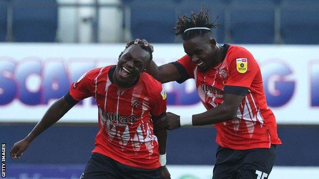 Admiral Muskwe (right) joins Luton team-mate Carlos Mendes Gomes on loan at the Highbury Stadium