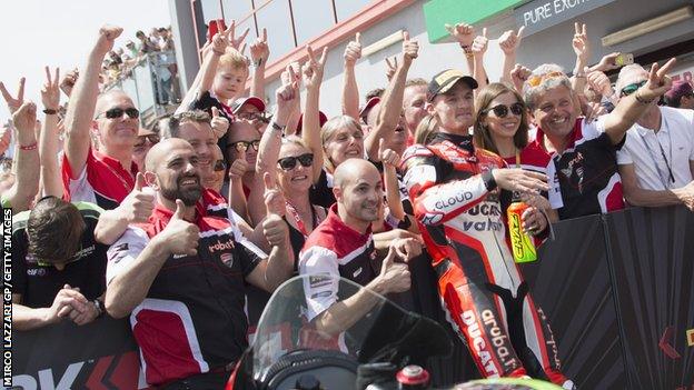 Chaz Davies celebrates a race victory with his Ducati team