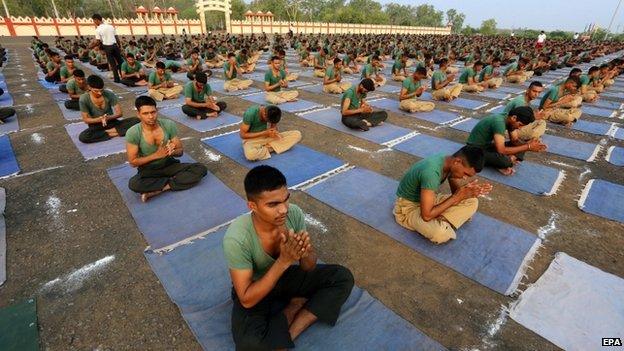 Indian Army personnel practice Yoga at a military station, ahead of World Yoga Day in Bhopal, India, on 20 June 2015.