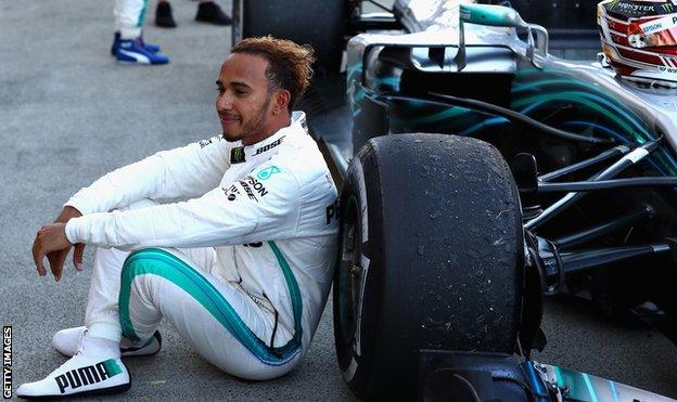 Lewis Hamilton sits by his car after the race